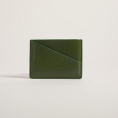 Compact cardholder with geometric design and blocked colors, crafted from natural apple peel and plant-based materials. This unique cardholder is all you need for a quick errand, with just enough space for an ID, cash and ATM cards. The sleek appearance will also complement any outfit. Personalization: Add hand painted letters & make your Allégorie bag more unique Dimensions: Approx. 4" L x 2.8" H Selected Material Certification USDA certification for biobased materials PETA certification for cr Modern Card Holder With Interior Slots For Daily Use, Modern Rectangular Wallets With Interior Card Slots, Modern Rectangular Wallet With Interior Card Slots, Modern Wallets With Card Slots, Modern Rectangular Card Holder With Interior Slots, Modern Rectangular Wallet With Card Slots, Green Bifold Everyday Card Holder, Everyday Green Bifold Card Holder, Modern Green Bifold Wallets