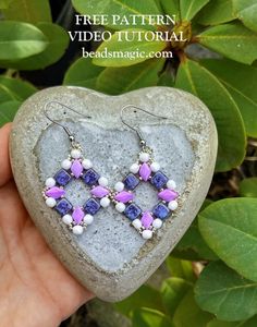 a heart shaped rock with purple and white beads