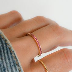 Sweet, simple, and dainty eternity band. Perfect for a minimalist look, or for stacking. ☆ Details ☆ * Made of 925 Sterling Silver * Available in 14k Gold Plating or Rhodium * We use a THICK, DURABLE plating - for a piece that will last you years to come! * VERY HIGH QUALITY * Available in sizes 4, 5, 6, 7, 8, 9, or 10 * Features stones throughout the entire ring * Measures 1.3mm in thickness * Made of Highest Grade Pink/Red CZ stones for an authentic Ruby Look * Also available in White CZ, Sapp Dainty Adjustable Half Eternity Jewelry, Stackable Adjustable Eternity Band For Everyday, Minimalist Adjustable Pink Stackable Rings, Minimalist Adjustable Ruby Promise Ring, Minimalist Half Eternity Band For Everyday, Stackable Adjustable Eternity Band, Minimalist Pink Rings For Everyday Wear, Adjustable Minimalist Stackable Eternity Band, Minimalist Adjustable Stackable Eternity Band