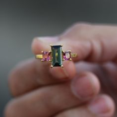 18k Solid Yellow Gold Emerald Cut Genuine Tourmaline & Square Pink Tourmaline Wedding Gift Ring, Handmade Solid Gold Jewelry Dainty Ring ≫ Features * Gemstone : 100% Natural Tourmaline Gemstone  * Emerald Cut Tourmaline = 9.80 X 5 MM * Square Cut Tourmaline = 4.0 MM (2 pcs ) * Band Thickness : 1.5 mm * 14k / 18k Solid Gold With Stamped  * 14K Solid Yellow Gold, ( Available in  14K Yellow Gold ,  14K Rose Gold & 14K White Gold ) * Option available in 18K Gold  * Size : All size available  * Ready Wedding Rings With Baguette Cut Tourmaline, Baguette Cut Tourmaline Jewelry For Weddings, Baguette Cut Tourmaline Jewelry For Anniversary, Baguette Cut Tourmaline Wedding Ring, Anniversary Tourmaline Jewelry In Baguette Cut, Wedding Multi-stone Sapphire Tourmaline Ring, Multi-stone Tourmaline Sapphire Ring For Wedding, Anniversary Baguette Cut Tourmaline Jewelry, Tourmaline Sapphire Multi-stone Wedding Ring