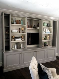 a living room filled with lots of furniture and bookshelves on top of each other