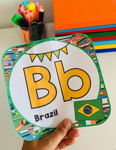 a hand holding up a sticker with the word blo written in brazil on it