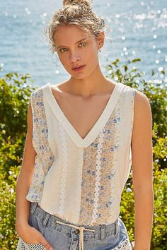 Designed in V-neck line oversized fit sleeveless knit top with rib and floral printed woven and trim. Handkerchief hem. Summer V-neck Knit Top For Day Out, V-neck Tank Top For Day Out In Spring, Chic V-neck Knit Top For Vacation, Chic Floral Print V-neck Tank Top, Spring Vacation V-neck Sweater Vest, Summer V-neck Knit Top, Summer V-neck Knit Top For Vacation, Bohemian V-neck Tank Top For Spring, Spring Bohemian Knit Top For Vacation