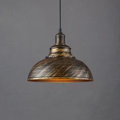 an antique style pendant light hanging from a metal ceiling fixture with a black cord attached to it