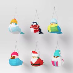 six christmas ornaments hanging from strings in the shape of birds