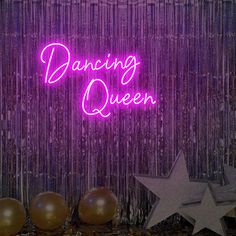 a neon sign that says dancing queen next to balloons