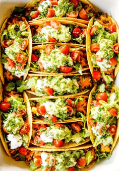 several tacos filled with various toppings in a white bowl