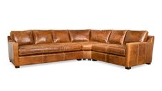 a brown leather sectional sofa sitting on top of a white floor