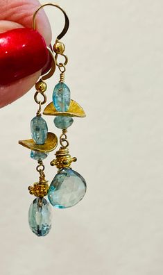 Topaz Earrings Gold dangle drop Earrings Blue gemstone earrings November birthstone by Gem Bliss.  Please note the actual sizes /details given as items may look different depending on your display.  * Images are enlarged to show detail.  ~ 14K Gold-filled Hook earrings.  ~ Topaz briolettes 11 mm.  ~ Apatite oval beads 8 mm.  ~ Apatite  rondelles 5 mm.  ~ 1-1/2-inch drop.  Amazing Aqua Blue Topaz Quartz and Apatite combination drop Earrings.  Sparkling faceted heart shape Topaz briolettes earrings.  Looking blue, then aqua and green this gem combination creates the glam for this Spring fresh earring.  One-of-a-kind luxury for the November birthday!  Lovely Mother's Day, Graduation, or Valentine's Day gift.  Apatite Topaz Earrings come with a jewelry pouch in a gift box tied with a lush ribb Nickel-free Blue Topaz Dangle Earrings, Blue Topaz Dangle Earrings, Turquoise Blue Topaz Dangle Earrings, Blue Topaz Faceted Dangle Earrings, Blue Topaz Gemstone Dangle Earrings, Faceted Blue Topaz Dangle Earrings, Blue Topaz Dangle Earrings With Gemstone, Handmade Blue Topaz Dangle Earrings, Blue Apatite Earrings Gift