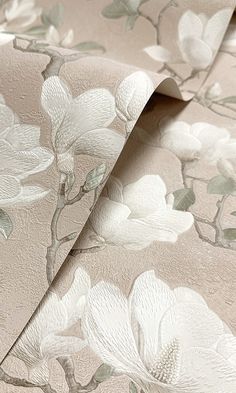 the wallpaper is decorated with white flowers and green leaves on light pink ground covering