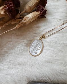 These gorgeous and unique rose carved pearl pendants are made out of real mother of pearl. The detail on the pearl pendant is a beautiful rose. Each piece will slightly differ due to its natural nature ✨ Necklace length I'm wearing is 20 inches  The gold on the pendant and the chain are both 18k gold plated ✨🌕 Mother of Pearl has spiritual symbolism and healing properties. It brings a gentle healing power of the sea and is stress relieving. Mother of Pearl also relaxes you and has healing benef Rose Gold Cameo Jewelry Gift, Rose Gold Cameo Jewelry For Gifts, Elegant Gold Plated Birth Flower Necklace, Elegant Engraved Mother Of Pearl Necklace, Elegant Jewelry With Flower Charm Oval Pendant, Elegant Oval Pendant Necklaces With Flower Charm, Elegant Oval Pendant Jewelry With Flower Charm, Elegant Oval Pendant Necklace With Flower Charm, Elegant Oval Pendant Jewelry With Birth Flower