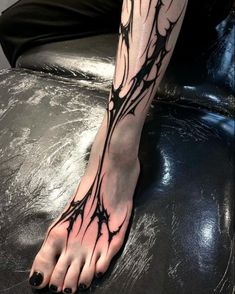 a person's bare foot with branches on it