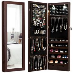 a large wooden jewelry cabinet with mirrors on the sides and shelves filled with necklaces