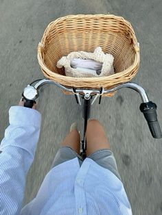 a person riding a bike with a basket on the back