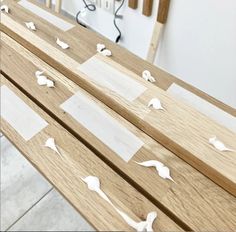 several pieces of wood with white paper on them sitting on top of each other in the middle of a room