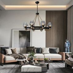 a living room filled with furniture and a chandelier hanging over the top of it