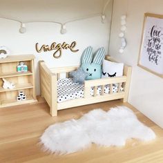 a dollhouse bedroom with white fur rugs on the floor and wooden furniture, including a baby's crib