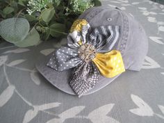 ALL ORDERS TOTALING OVER $35 SHIP FREE I designed this light grey trucker baseball cap making an adorable coordinating fabric petal flower. I added a beautiful matching rhinestone accent to the center of the flower.  This hat is so cute.  See more of my  hats here: http://www.etsy.com/shop/theraggedyrose?section_id=10557807 CUSTOM ORDERS ALWAYS WELCOME.... Will ship in 1 to 2 business days after payment is received.  Thanks for taking the time to stop by and look at my little shop. Hope you enjoyed. Thanks so much.  Contact me with any questions you may have. M Gray Baseball Cap For Spring, Gray Cap For Spring, Gray Spring Cap, Gray Snapback Hat For Spring, Adjustable Gray Hat For Gift, Gray Curved Bill Hat For Summer, Adjustable Brimmed Gray Baseball Cap, Gray Curved Brim Baseball Cap For Spring, Gray Brimmed Baseball Cap, One Size Fits Most