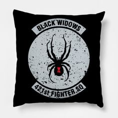 a black pillow with the words black widows and a spider on it's back