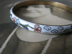 This is a beautiful vintage white cloisonne bracelet from the 1970's. It measures 7mm wide x 3mm thick. It is 2 5/8'' across on the inside, and 8'' around the inside. It is in good vintage condition with a Shabby Oriental grace. Perfect as a gift to a bride, or add it to your sweet collection. Vintage White Bangle For Wedding, Vintage White Wedding Bangle, Vintage White Bangle Bracelets, Vintage White Handmade Bangle, Collectible White Bracelet Jewelry, Adjustable White Vintage Bangle, Cloisonne Bracelet, Art Deco Locket, Keys Wedding