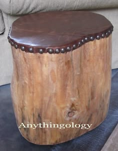 a stool made out of a tree stump with chocolate colored paint on the top and bottom