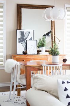 a living room filled with furniture and a large mirror above the table on top of it