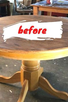 a wooden table with the words before painted on it's top in red and white