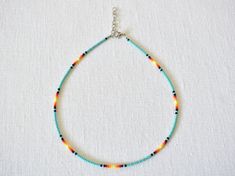 The Island Sunset beaded choker has swirls of red, orange, and yellow fading into a beautiful island turquoise. Watch the day turn to night in this elegant beaded necklace! The standard bedazzling choker is 13 inches long with an adjustable 2-inch extender chain to comfortably fit any size neck. If you would like a different length, please select the size you would like and I'll be happy to adjust it! Perfect for layering with other necklaces or chokers and great to wear with any outfit. It is c Elegant Beaded Necklace, Anklet Ideas, Pony Bead Bracelets, Trendy Chokers, Seed Bead Jewelry Patterns, Seed Bead Choker, Island Sunset, Necklace Trendy, Indie Jewelry