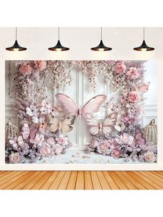 pink flowers and butterflies on a white wall with three lights hanging from the ceiling above them