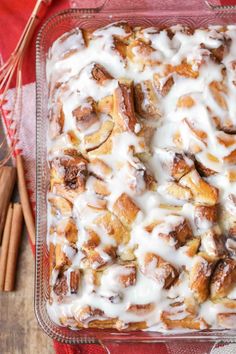 a casserole dish with cinnamon rolls and icing