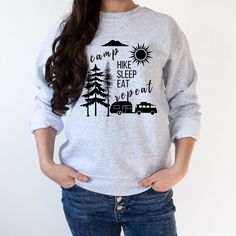 "This is a camping sweatshirt for a nature and adventure lover featuring camping graphics and funny saying Camp Hike Sleep Eat Repeat. Great Gift for any camper. Ideal for any situation, a unisex heavy blend crewneck sweatshirt is pure comfort. These garments are made from polyester and cotton. This combination helps designs come out looking fresh and beautiful. The collar is ribbed knit, so it retains its shape even after washing. There are no itchy side seams on these sweaters.  .: 50% cotton, 50% polyester .: Medium-heavy fabric (8.0 oz/yd² (271.25 g/m .: Loose fit .: Sewn-in label .: Runs true to size HOW TO ORDER: 1.Choose your unisex sweatshirt size, refer to the Size Chart 2.Choose sweatshirt color from the drop downs. 3.Complete this process for every additional item you decide to Outdoor Cotton Sweatshirt, Relaxed Fit Letter Print Sweatshirt For Outdoor, Relaxed Fit Graphic Sweatshirt For Camping, Long Sleeve T-shirt With Letter Print For Camping, Camping Sweatshirt, Funny Camping, Hiking Shirt, Camping Humor, Hiking Shirts