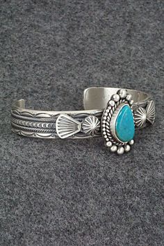 This Kingman turquoise and sterling silver bracelet was made by Navajo silversmith Michael Calladitto. The inside is signed MC and stamped Sterling.Size: 5 3/4" (will fit up to a 7 1/8" wrist)Gap: 1 3/8"Width: 1 1/8"Cuff Width: 1/2"Free shipping on all orders! We ship with USPS and always include tracking. All orders ship within a day of payment.Returns are accepted up to 30 days after you receive your order. Just send us a message. Our shop offers cash back or store credit. The item must be ret Kingman Turquoise, Sterling Silver Bracelet, Native American Jewelry, Turquoise Sterling Silver, Sterling Silver Bracelets, Silver Bracelet, Gap, Cuff, Stamp