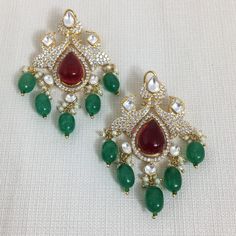 Polki Earrings, reflecting the charm of Sabyasachi's finesse. These Green Kundan Earrings and Ruby Polki Jewelry embody opulence, showcasing the allure of Emerald Kundan Studs and Polki Diamond elements. The Emerald Earrings and Polki details exude regal allure, offering a statement of sophistication and cultural richness. Indulge in the resplendent beauty of these pieces, where every facet captures the artistry of craftsmanship, creating a captivating blend of elegance and opulence. *𝐏𝐑𝐎𝐃𝐔 Polki Earrings, Polki Jewellery, Kundan Earrings, Kundan Jewellery, Emerald Earrings, Designer Earrings, Statement Jewelry, Wedding Shop, Jewelry Sets