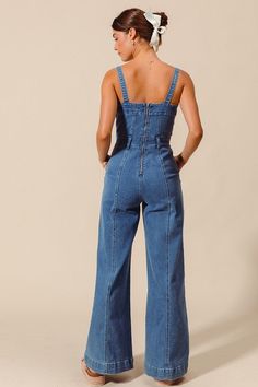 Say hello to your new summer staple, the Kelsie Jumpsuit! This medium wash denim jumpsuit features a sleeveless design with thick shoulder straps for comfort and style. Complete with side pockets and a back zipper closure, and a wide leg silhouette for a trendy touch. Details + Fit 75% Cotton | 23% Polyester | 2% Spandex Runs True to Size Machine Wash Cold Hang To Dry Square Neckline Sleeveless Beltloops Back Zipper CLosure Side Pockets Wide Leg Medium Wash | Solid Model is 5'8" and wearing a si Spring Medium Wash Overalls With Adjustable Straps, Trendy Light Wash Denim Overall Jumpsuit, Trendy Light Wash Denim Overalls, Denim Blue Jumpsuit With Adjustable Straps, Cotton Denim Jumpsuit With Adjustable Straps In Medium Wash, Summer Denim Overalls With Adjustable Straps, Trendy Light Wash Overall Jumpsuits, Cotton Denim Jumpsuit With Adjustable Straps, Summer Medium Wash Overalls With Adjustable Straps