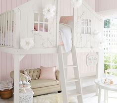 a white loft bed sitting next to a pink wall