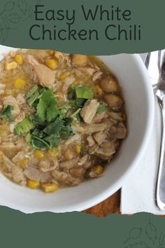 a white bowl filled with chicken chili and garnished with cilantro