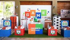 an image of a birthday party setting with games on the table and decorations in boxes