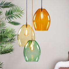 three different colored lights hanging from a ceiling