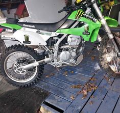 a dirt bike parked on top of a wooden platform