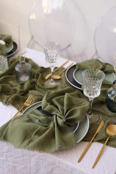 the table is set with green napkins and silverware