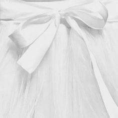 a white dress with a big bow on it