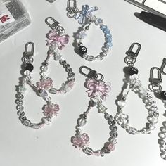 several different types of bracelets sitting on a table next to a computer mouse and keyboard