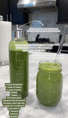 two jars filled with green liquid sitting on top of a counter next to each other