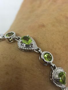 This Peridot bracelet is very lively and bright. The stones are deep colors and well matched. The sterling silver is plated with rhodium to protect the bracelet from tarnish and give the appearance of white gold. 7.5 inches My jeweler can shorten it All jewelry is shipped in a nice gift box. Check out our over a THOUSAND great reviews Engraving is $4 per letter and is not always perfect depending on the piece. It can take a few days if the jeweler is busy. This is payable to Paypal Judithsltd@gm Green Multi-stone Round Bracelets, Green Sterling Silver Bracelet With Polished Finish, Green Oval Sterling Silver Bracelets, Green Round Sterling Silver Bracelet, Green Sterling Silver Bracelets With Polished Finish, Green Oval Sterling Silver Bracelet, Oval Green Sterling Silver Bracelet, Anniversary Green Sterling Silver Bracelets, Green Sterling Silver Round Bracelet