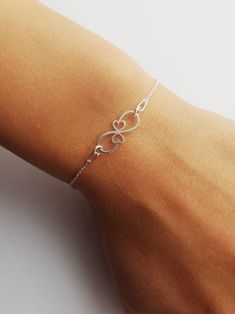 Lovely Infinity solid silver 925 women's bracelet. Charm design jewelry. Double hearts motif. Gift idea for mother of twins. Simply jewelry.  Dainty Infinity bracelet for girl.  Anniversary present idea for her.  This pretty bracelet is made of sterling silver 925.  Length 16cm + Adjustable 4cm Ready to ship in 1-3 business days. Visit our shop here  https://etsy.me/2YxPw10 Visit our Facebook Page 👇👇 https://www.facebook.com/KatoO-Jewelry-320908688837927/ Elegant Sterling Silver Heart Bracelet Gift, Minimalist Bracelets As Gift For Mom, Sterling Silver Double Heart Bracelet Gift, Silver Hypoallergenic Heart Bracelet, Infinity Heart Bracelet For Anniversary, Elegant Infinity Heart Bracelet As Gift, Elegant Infinity Heart Bracelet Gift, Elegant Heart-shaped Bracelet For Mom, Sterling Silver Infinity Bracelets For Anniversary