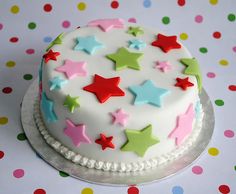 a white cake with colorful stars on it