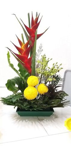 a vase filled with yellow flowers on top of a table