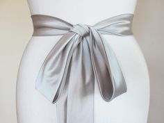 Silver Fitted Bridal Belt For Formal Occasions, Elegant Ribbon Bridal Belt For Wedding, Elegant Bridal Belt With Satin Bow For Wedding, Elegant Satin Sash With Tie Back, Satin Sash With Bow For Bridesmaids, Elegant Tie Back Sash For Formal Occasions, Fitted Satin Bridal Belt For Bridesmaid, Wedding Satin Tie Back Sash, Elegant Formal Sash With Tie Back