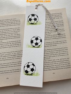 two bookmarks with soccer balls painted on them