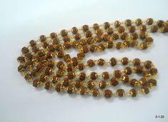 "20kt gold and rudraksha beads chain necklace mala (108+1=109 Beads) from rajasthan india. great handmade chain, good for jewellery collection. Note - Please check pictures carefully for more details. Length - 102 cm(40.2\") we can adjust the length. Thickness - 6/6.5 mm gross weight approx - 29.5 grams gold weight approx - 20 grams Material - 20kt yellow gold & rudraksha beads." Brown Necklaces For Puja And Festivals, Festival Brown Necklace For Puja, Gold Mala With 8mm Beads For Meditation, Gold Hand-strung Mala For Meditation, Gold Mala With 108 Beads For Meditation, Gold 108 Beads Mala For Meditation, Handmade Gold Temple Jewelry Mala, Gold Mala With Gold Beads For Puja, Gold Temple Necklace With Gemstone Beads For Festivals